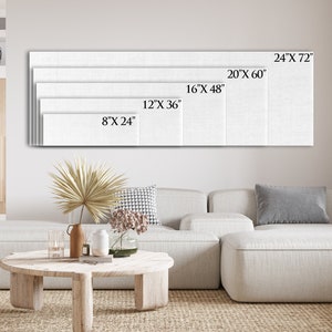 May include: A white canvas print with different size options displayed on a wall above a white sectional sofa. The sizes are 8" x 24", 12" x 36", 16" x 48", 20" x 60", and 24" x 72".