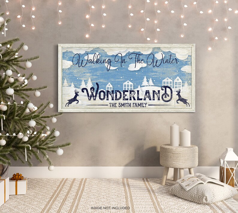May include: A blue and white sign with the text "Walking in the Winter Wonderland - The Smith Family". The sign features a winter scene with snow-covered houses and trees, and two deer.
