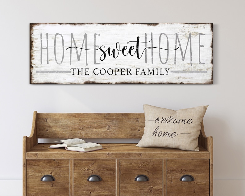 May include: White wooden sign with black text that reads "Home sweet Home" and "The Cooper Family".