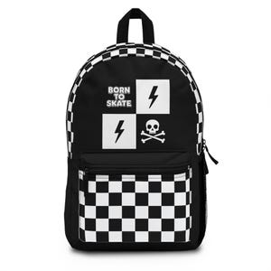 May include: Black backpack with a white and black chequered pattern and a front pocket. The backpack features the text "BORN TO SKATE" with lightning bolt and skull graphics. The backpack has a black handle and zip.