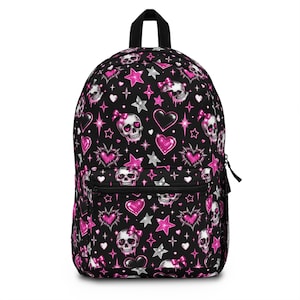 May include: A black backpack featuring an all-over print of white skulls with pink bows, vibrant pink glittery hearts, and silver stars. The bag includes a front zippered pocket, a top handle, and black zippers, showcasing a repeating graphic pattern.