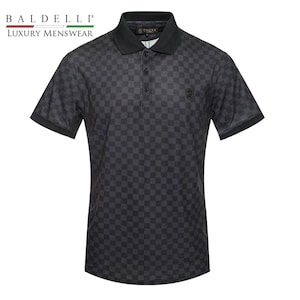 May include: A black polo shirt with a checkered pattern. The shirt has a black collar and a small logo on the chest.