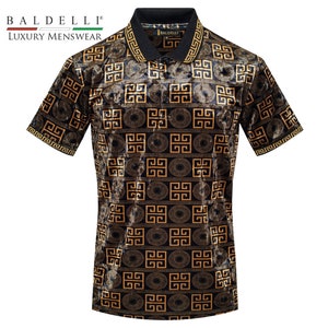 May include: A black short-sleeved polo shirt with a gold geometric pattern. The shirt has a collar and a button closure. The brand name "BALDELLI" is printed on the shirt.