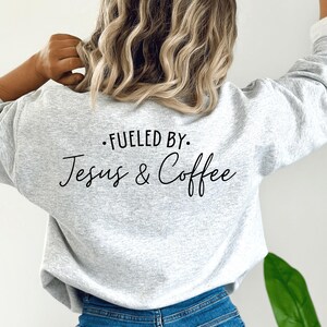 May include: Gray sweatshirt with the text "Fueled by: Jesus & Coffee" printed on the back.