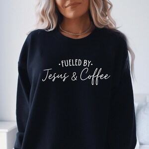 May include: Black sweatshirt with the text "Fuelled by Jesus & Coffee" in white lettering.
