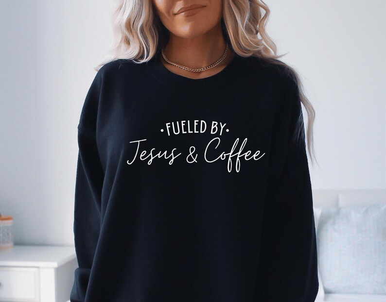 May include: Black sweatshirt with the text "Fuelled by Jesus & Coffee" in white lettering.