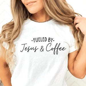 May include: White t-shirt with black text that reads "Fueled by: Jesus & Coffee".