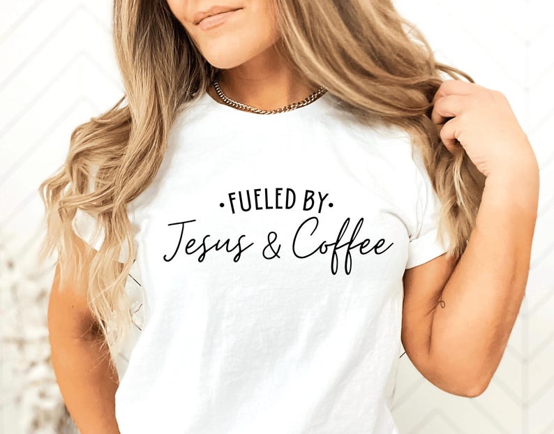 May include: White t-shirt with black text that reads "Fueled by: Jesus & Coffee".