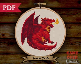 May include: A red dragon cross-stitch pattern with a 9-inch circle hoop. The dragon is breathing fire and has a red and yellow color scheme.