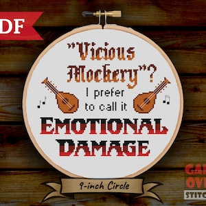May include: A white cross-stitch pattern on a 9-inch hoop with the text "Vicious Mockery? I prefer to call it EMOTIONAL DAMAGE" and two lute-like instruments. The text is in a black and red gradient.