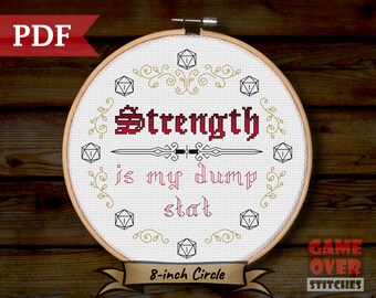 May include: An 8-inch round cross-stitch pattern featuring a red and white design with the text "Strength is my dump stat" and a sword graphic. The pattern is surrounded by gold vines and dice.