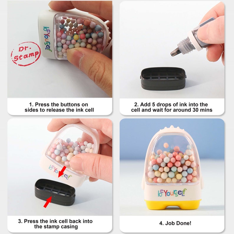 May include: A clear plastic stamp with a yellow base and a white lid. The stamp has a compartment filled with colorful beads and the text "be yourself" printed on the front. The stamp is shown in four steps: 1. Pressing the buttons on the sides to release the ink cell. 2. Adding 5 drops of ink into the cell. 3. Pressing the ink cell back into the stamp casing. 4. Job done!