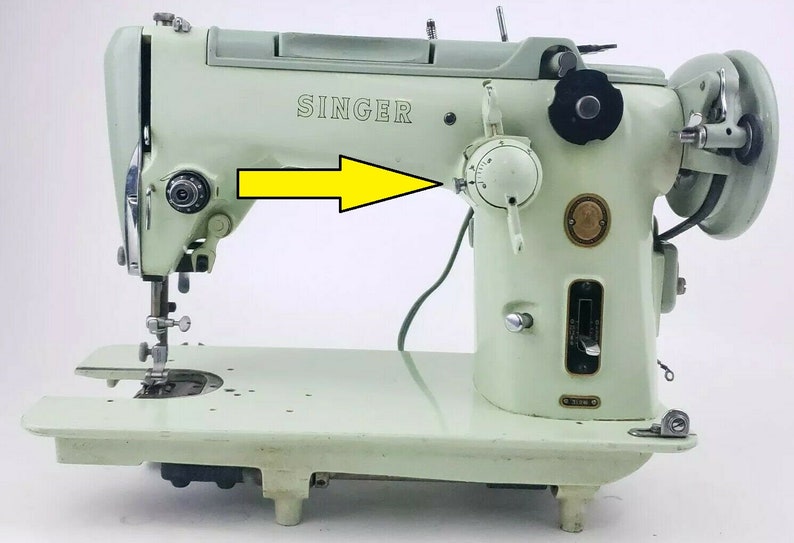 May include: A vintage Singer sewing machine in a light green color. The machine has a metal foot pedal and a knob for adjusting the stitch length. The machine is in good condition and has a few minor scratches.