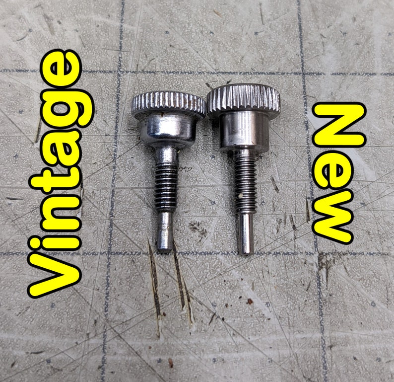 May include: Two silver metal knobs, one labeled "vintage" and the other "new". The knobs are similar in design but have slight differences in their finish.
