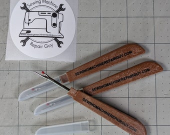 Three seam rippers and one logo sticker for Sewing Machine Repair Guy
