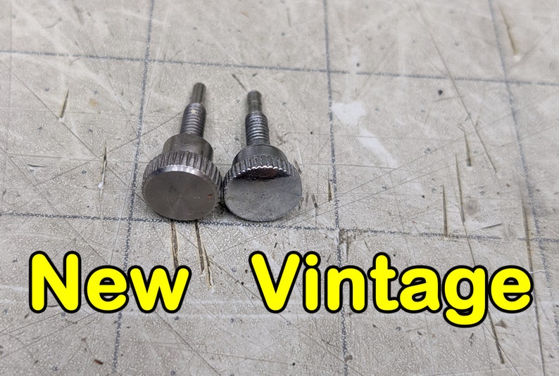 May include: Two silver metal screws with knurled heads. The screw on the left is labeled "New" and the screw on the right is labeled "Vintage".