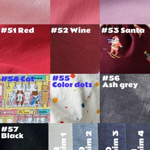 May include: A selection of fabric swatches showcasing diverse colours and patterns. Includes pink, red, wine, and denim shades. Also features a Santa-themed fabric, a cat print, a white fabric with coloured dots, and a black fabric.