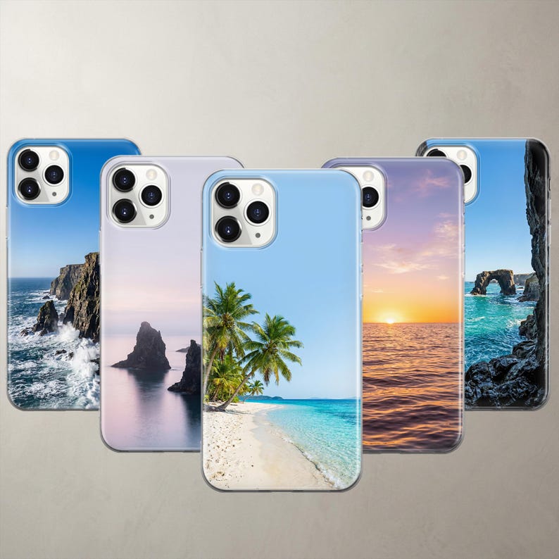 A product collage displaying five photorealistic nature phone cases for Apple iPhone and Google Pixel models. The designs feature breathtaking high-definition coastal photography, including dramatic ocean cliffs, mystic sea rocks, a vibrant tropical beach, a golden ocean sunset, and a coastal stone arch, all set against perfectly clean, clear blue skies.