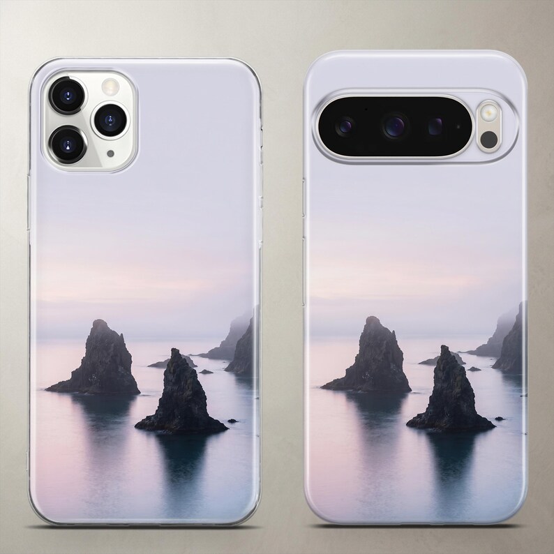 Scenic nature phone case featuring a calming view of mystic dark sea rocks resting in still water under a clear, soft pastel sky.
