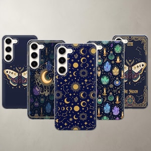 May include: Five smartphone cases featuring dark blue backgrounds with celestial and mystical designs. Patterns include gold suns, moons, stars, constellations, colorful crystals, lit candles, potion bottles, and a moth with the text The Moon.
