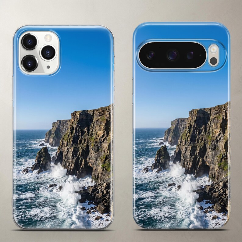 Photorealistic phone case featuring a scenic coastal landscape of rugged ocean cliffs, crashing white waves, and a perfectly clean blue sky.