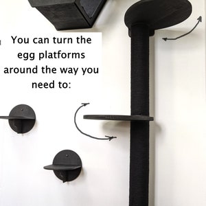 May include: Black cat tree with multiple platforms. The platforms are round and can be turned to face different directions. The text "You can turn the egg platforms around the way you need to." is visible in the image.