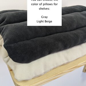 May include: Two cushions, one gray and one light beige, are stacked on a wooden shelf. The text "You can choose the color of pillows for shelves: Gray Light Beige" is visible above the cushions.