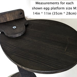 May include: A black wooden cat perch with a round platform measuring 14 inches by 11 inches (35 cm by 28 cm).