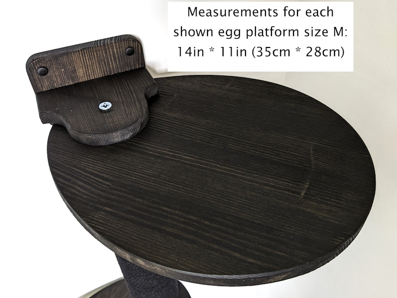 May include: A black wooden cat perch with a round platform measuring 14 inches by 11 inches (35 cm by 28 cm).