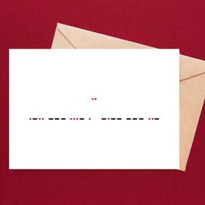 May include: A white card with a message written in Morse code using black dashes and red dots. The message reads "I love you".