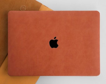 May include: A brown leather laptop case with an Apple logo.