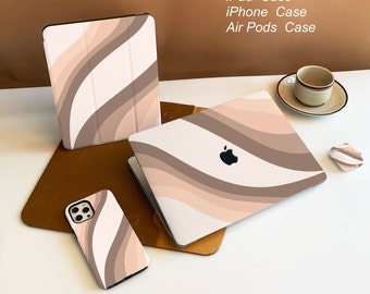 May include: A set of four phone cases with a wavy abstract design in shades of brown, beige, and white. The cases are for a MacBook, iPad, iPhone, and Airpods.  MacBook Case iPad Case iPhone Case Air Pods Case