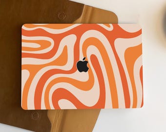May include: Orange and white abstract swirl pattern laptop skin with an apple logo in the centre.