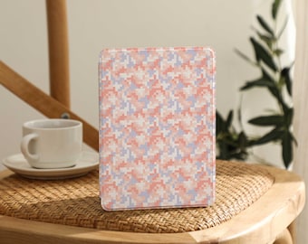 May include: A pink and blue geometric patterned case for an e-reader. The case is made of a hard plastic material and has a smooth finish.