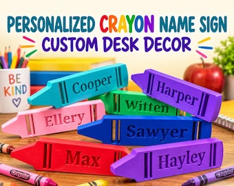 May include: A collection of personalized crayon-shaped name signs in various colors including teal, purple, pink, blue, red, and violet. Each sign features a name engraved on the side, such as Cooper, Harper, Witten, Ellery, Sawyer, Max, and Hayley.