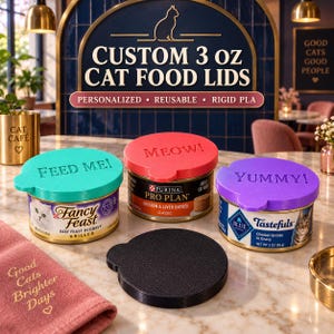 May include: Four circular, reusable, rigid PLA cat food lids in teal, red, purple, and black. The teal lid is embossed with 'FEED ME!', the red with 'MEOW!', and the purple with 'YUMMY!'. These lids are designed to fit standard 3 oz cat food cans.