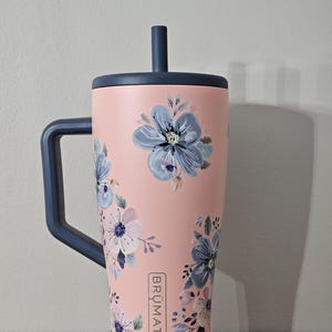 30 oz. stainless steel tumbler in the color guava & nightfall with flower uv dtf decals.