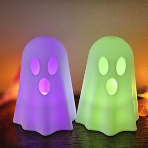 3d printed ghosts. Set of 2 Comes with 2 battery operated color changing tealights. Size measurements are included in the photos.