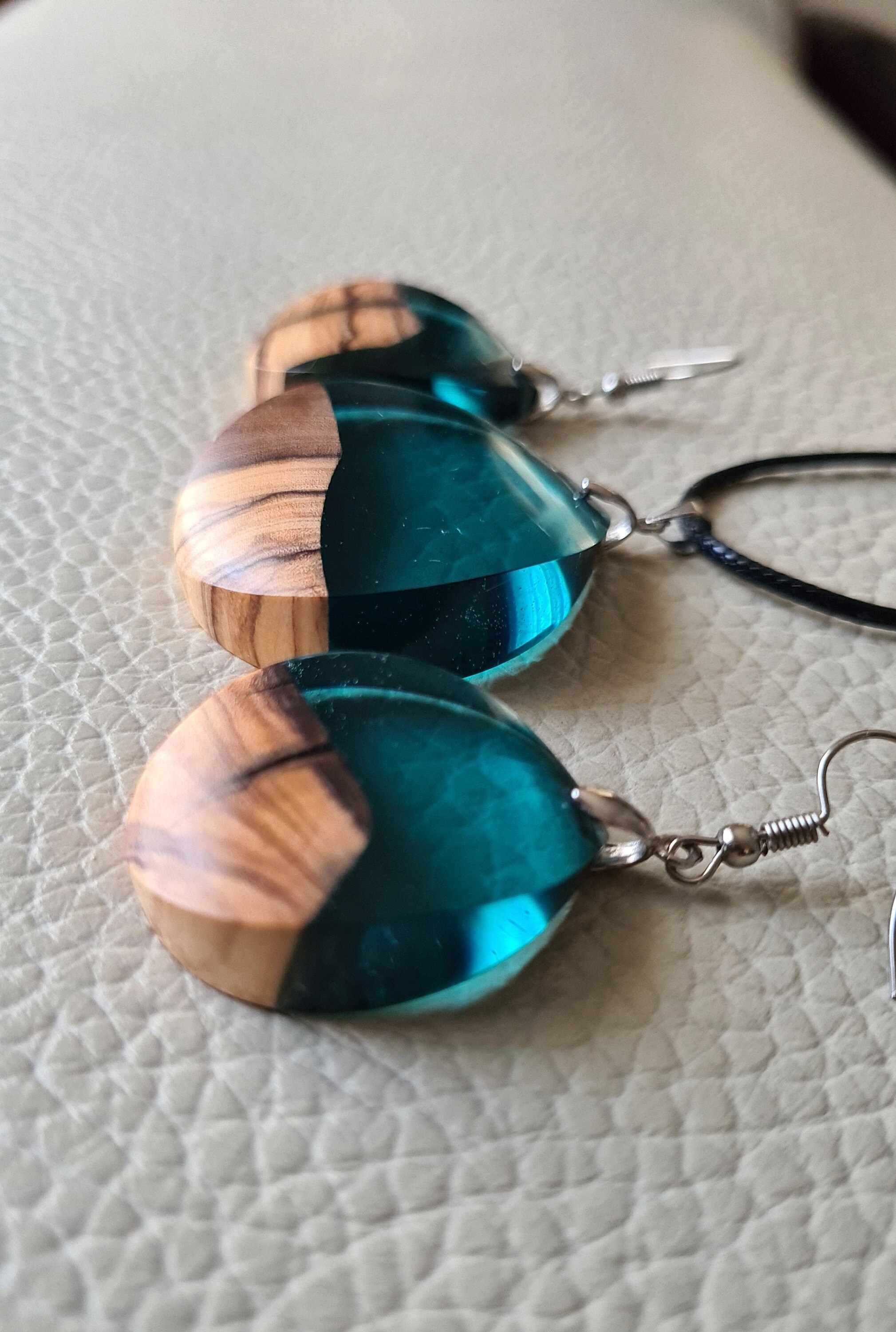 Unique jewelry set, earrings and necklace made of olive wood and resin in blue petrol color.