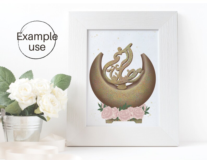 May include: A gold crescent moon with a glittery texture and a stylized Arabic calligraphy design in the center. The moon is surrounded by pink roses and green leaves on a white background.