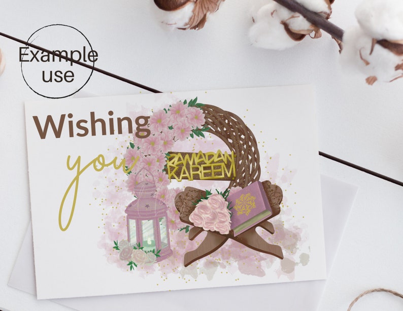 May include: A greeting card with a watercolor background featuring a wreath of pink flowers, a lantern, a book, and a sign that reads "Ramadan Kareem". The text "Wishing you" is written in gold script.