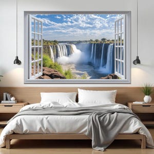 May include: A white window frame with a view of a waterfall cascading over rocks. The waterfall is surrounded by lush green foliage and a blue sky with white clouds. The window is open, creating a sense of depth and perspective.