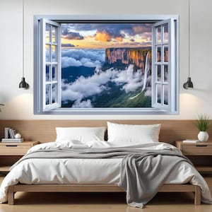 Può includere: Una cornice di finestra bianca con vista su una catena montuosa con una cascata che scende lungo il fianco. La catena montuosa è coperta di nuvole e il cielo è di un arancione e un blu vibranti.