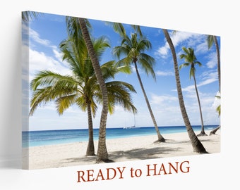 May include: A canvas print featuring a beach scene with palm trees, white sand, and blue water. The print has the text "READY to HANG" at the bottom.