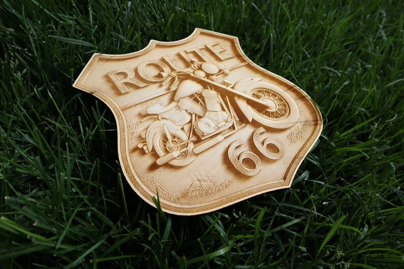 May include: A wooden sign with a vintage motorcycle design and the text "ROUTE 66" in raised letters. The sign is shaped like a shield and has a distressed, weathered look.