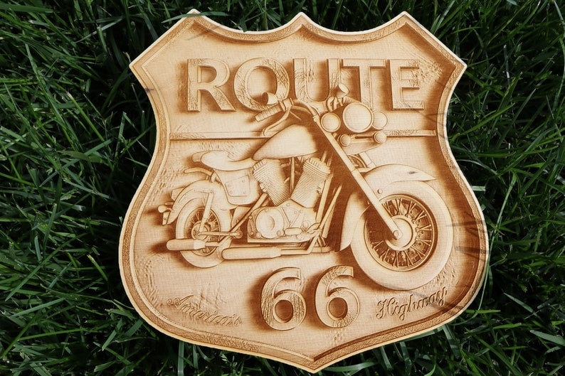 May include: A wooden sign with a vintage motorcycle design. The sign is shaped like a shield and features the text "ROUTE 66 Highway".