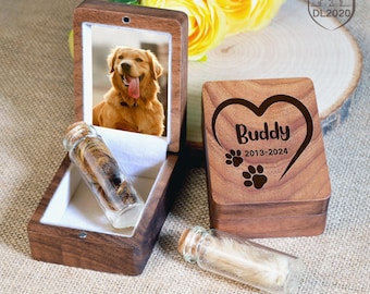 May include: A wooden box with a heart-shaped engraving that says "Buddy 2013-2024" and a paw print design. The box is open and contains a small glass vial with fur inside. A photo of a golden retriever is in the lid of the box.