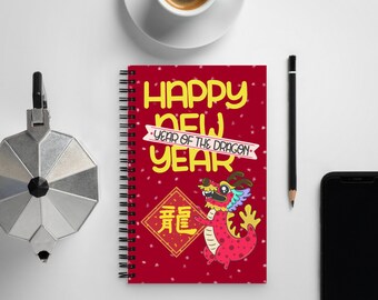 May include: Red spiral bound notebook with a colorful illustration of a dragon and the text "Happy New Year - Year of the Dragon" in yellow letters. The dragon is holding a red banner with the Chinese character for "dragon" in gold.