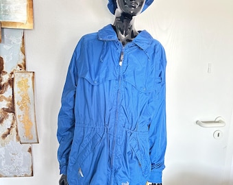 May include: A blue hooded jacket with a zipper closure and a drawstring at the waist. The jacket has a small logo on the left side that says "CHB".