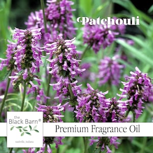 May include: Close-up of vibrant purple flowers with the word "Patchouli" in white text. The image also includes the text "Premium Fragrance Oil" and the logo for "The Black Barn" with the location "Nashville, Indiana".